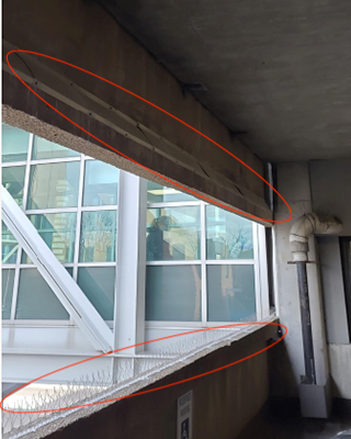 Metal angle deterrent and spikes in hospital garage